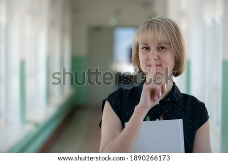 Teacher asks to be quiet at school. Examination time.