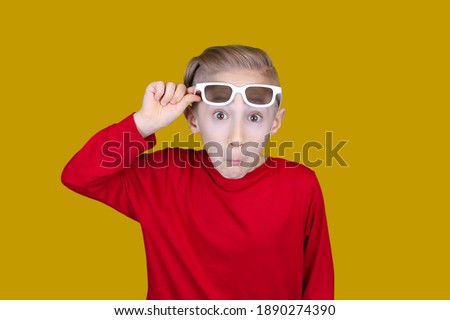 the child pulls on the forehead of children's 3D glasses and makes funny faces