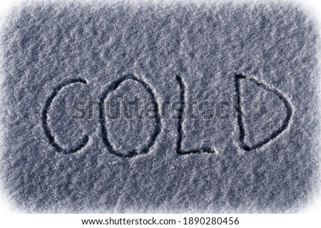 Word cold hand written on surface of the snow