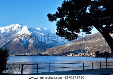 Picture of Monte Bregagno taken from the Domaso shore on the Como lake, with its colored houses on the right.