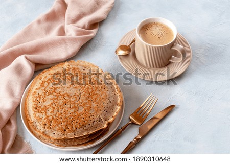 French buckwheat pancakes with a cup of coffee for breakfast. Royalty-Free Stock Photo #1890310648