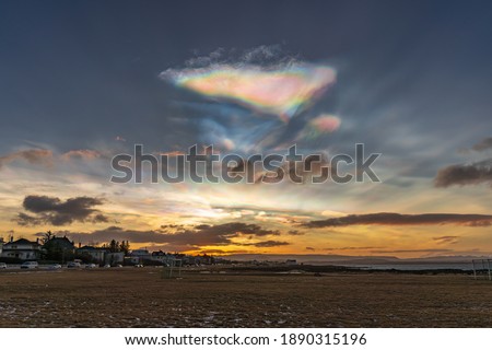 Polar stratospheric clouds and sunrise. Nacreous clouds. Rainbow clouds and the Atlantic Ocean coast Royalty-Free Stock Photo #1890315196