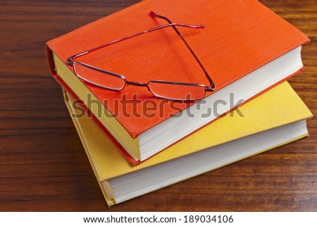 old dusty books and glasses on the wooden table