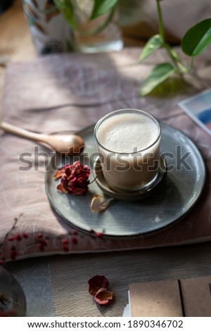 Women time for self care and relax: Pink styled picture of coffee, rose petals and wild flowers with comfortable pillows. Coffee break, stress relief, meditation, self care concept. Top view, flatlay.