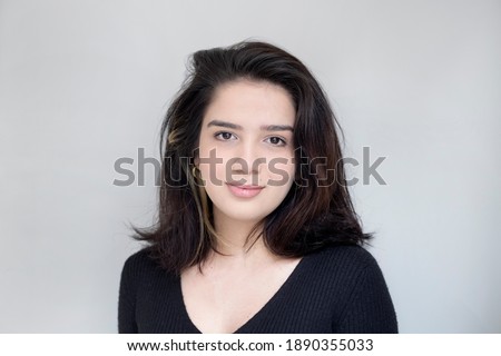 portrait of a beautiful girl on gray background