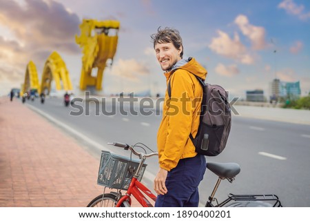 A man rides a bicycle on the dragon bridge in Da Nang