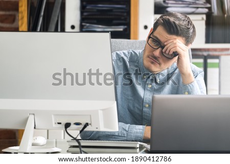 Bored Unhappy Man Watching In Online Virtual Lecture Webinar Royalty-Free Stock Photo #1890412786