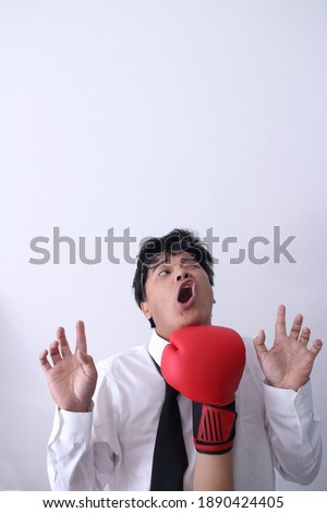 Business man getting punch with boxing glove.