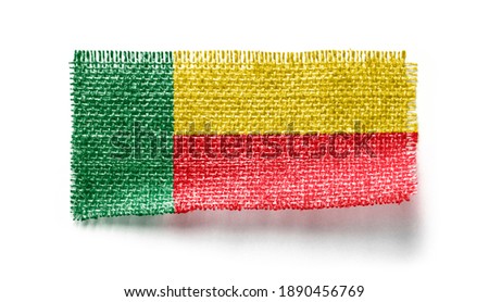 Benin flag on a piece of cloth on a white background