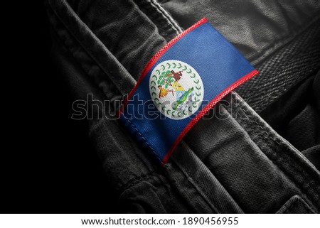 Tag on dark clothing in the form of the flag of the Belize