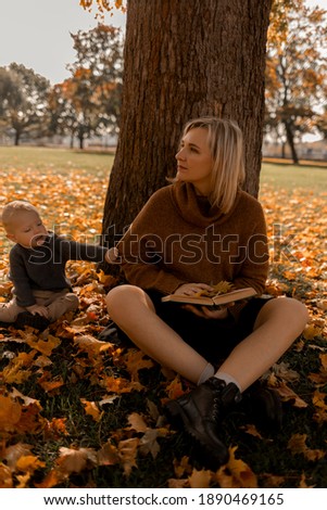 autumn photo session of a girl with her son in the park