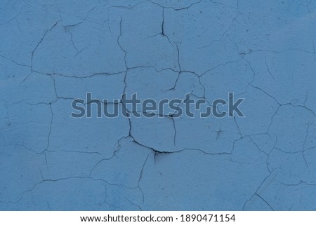 Cracked plaster structure. Background, texture Neutral blue color, structure