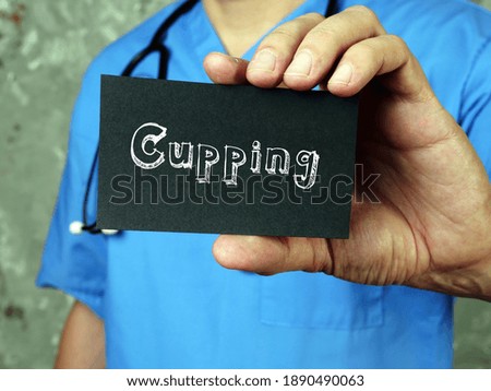Health care concept meaning Cupping with sign on the piece of paper.
