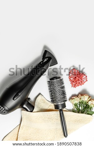 composition with hairdressing tools and flowers on a white background. Template for a postcard or information about a hair salon. flat lay, copy space