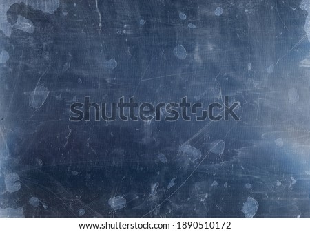 Distressed overlay. Weathered screen. Stained aged damaged monitor surface with dust scratches dry smeared dirt drip on dark blue old grunge background.