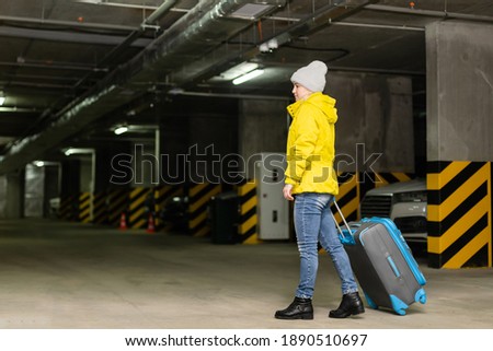 woman walking with bag in the underground parking