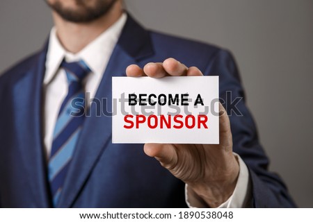 Become a Sponsor. Investment, Business Concept. Businessman holding a card with a message text written on it Royalty-Free Stock Photo #1890538048