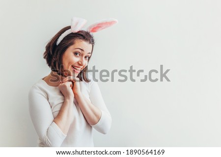 Happy Easter holiday celebration spring concept. Young woman wearing bunny ears isolated on white background. Preparation for holiday. Girl looking happy and excited, having fun on Easter day