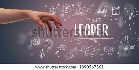 Close-Up of cropped hand pointing at LEADER inscription, modern business solution concept