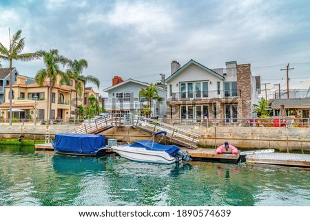 Small leaisure boats on canal in the picture perfect neighborhood of Long Beach