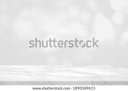Empty Marble Table with White Bokeh on Concrete Wall Background for Product Presentation.