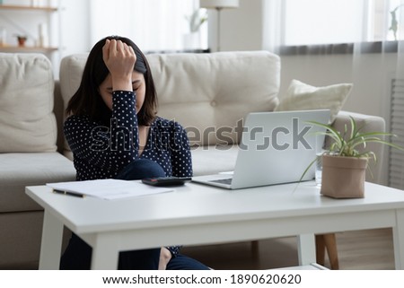 Unhappy young korean asian woman calculating monthly expenses feeling stressed about not enough money, confused mixed race lady suffering from financial problems, bankruptcy or overspending savings. Royalty-Free Stock Photo #1890620620