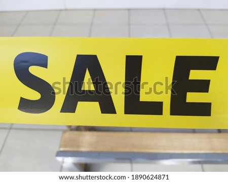 Text sale on the yellow tape