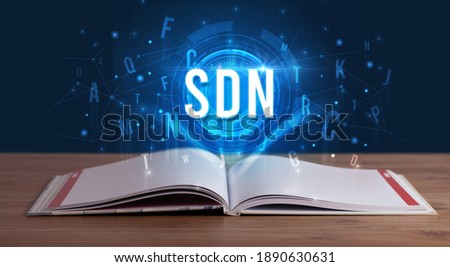 SDN inscription coming out from an open book, digital technology concept