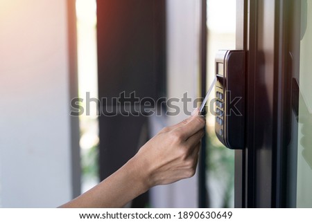 young woman using RFID tag key card, fingerprint and access control to open the door in a office building Royalty-Free Stock Photo #1890630649