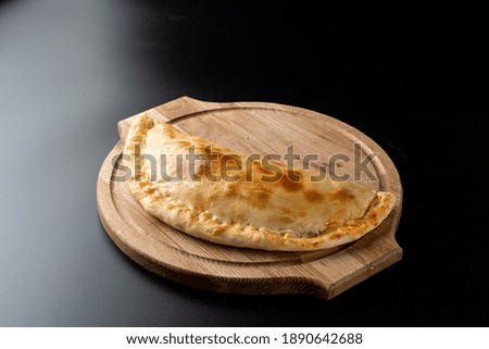 Menu photo of italian golden calzone, made in a stove