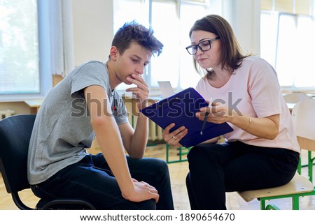 Woman school psychologist talking and helping student, male teenager. Mental health of adolescents, psychology, social issues, professional help of counselor Royalty-Free Stock Photo #1890654670