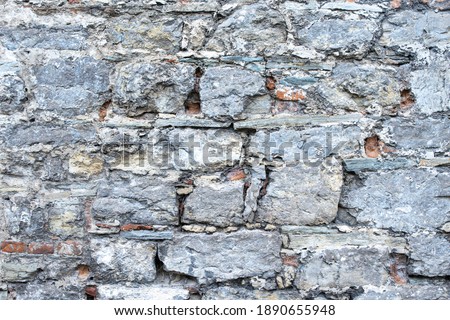 Background and texture of an old stone wall close up.