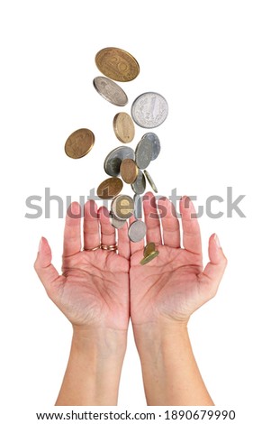 Various money coins rain falling down in to hands, isolated on a white background