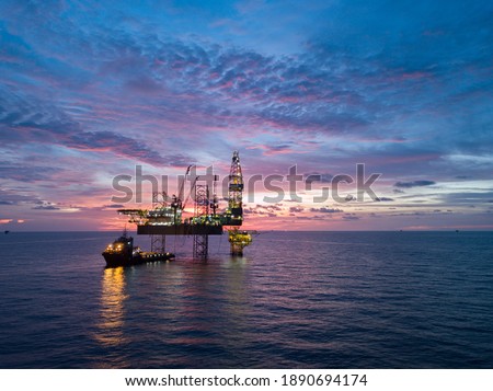 Aerial view offshore drilling rig (jack up rig) at the offshore location during sunset Royalty-Free Stock Photo #1890694174