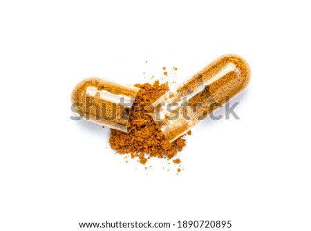Turmeric herbal powder capsules isolated on white background. Top view. Flat lay. Royalty-Free Stock Photo #1890720895