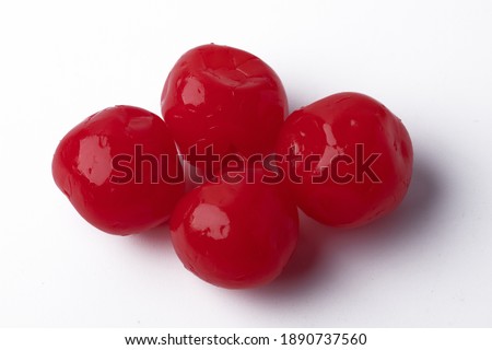 Fresh red candied cherries on a white background