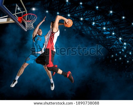 Two basketball players in action in arena. Blocked shot Royalty-Free Stock Photo #1890738088