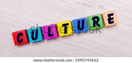 On a light wooden background on multi-colored bright wooden cubes the word CULTURE