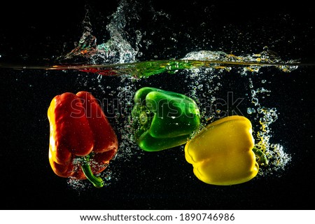 Three peppers dropped into water