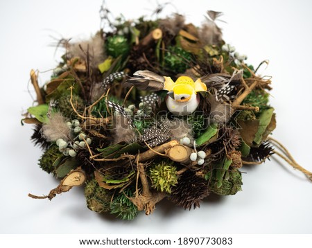 Easter composition. Easter wreath with little bird on white background. Perspective view.