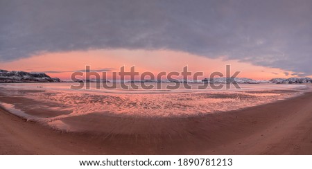 Wide panoramic view of winter sunset with amazing magenta color over fjord