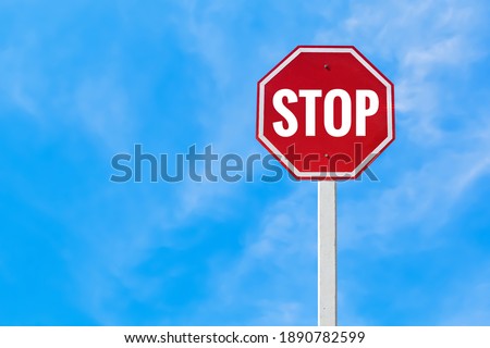 Traffic sign; Isolated ’STOP’ sign on pole with clipping paths.