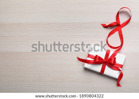 8 March greeting card design with gift box and space for text on wooden background, flat lay. International Women's day