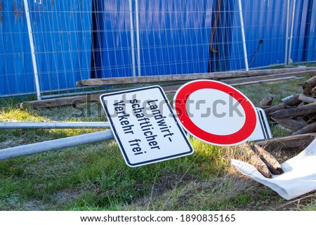 Close up of a German traffic sign with the German lettering "Landwirtschaftlicher Verkehr frei" meaning agricultural traffic entry free, on the ground  at construction site
