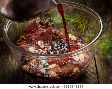 Fresh game meat marinated in red wine sauce with wild herbs and garlic Royalty-Free Stock Photo #1890848953