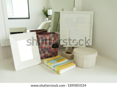 Picture frame and book on a dresser in a bedroom