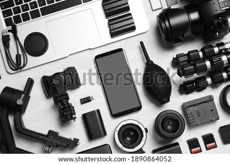 Camera and video production equipment on light background, flat lay