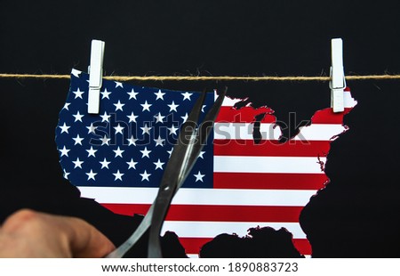 map of america USA is split with scissors - as a symbol of crisis and chaos of division in country