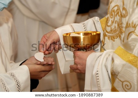Communion rite during mass in a Catholic church Royalty-Free Stock Photo #1890887389