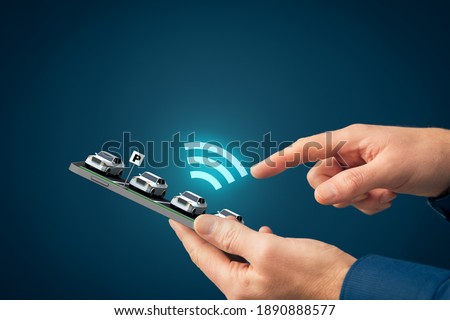 Intelligent car app on smart phone concept, intelligent vehicle and smart cars concept. Person searching for his car in the parking lot using the app on his mobile phone. Royalty-Free Stock Photo #1890888577